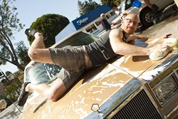 PIN-UP KING! :  Mike strikes a pose on the hood of a Chrysler. - PHOTO BY STEVE E. MILLER
