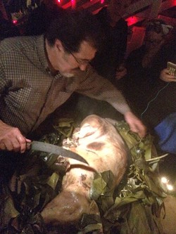 CARVING TIME:  George Griffin, the driving force behind the pig roast, prepares to carve into the perfectly roasted pig. - PHOTO BY GEORGE GRIFFIN AND GLEN STARKEY