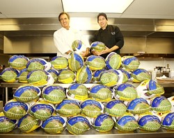 BIRD IS THE WORD :  Jose Dahan (left) and sous chef Jason Chenaux (right) of Et Voila were already preparing for Thanksgiving on Nov. 13 when a load of turkeys arrived at the restaurant. - PHOTO BY STEVE E. MILLER