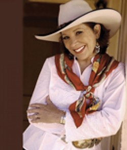 COLORFUL COWGAL :  Juni Fisher, Western Musics Female Vocalist of the Year, will play on April 25 in Paso Robles Divine Appointment Guitars. - PHOTO COURTESY OF JUNI FISHER