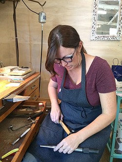 SOLDERING AWAY:  Jeweler Kerry Long cuts, solders, and hammers away at her workspace at The Bunker in SLO as she creates one-of-a-kind metal jewelry. - PHOTO COURTESY OF KERRY LONG