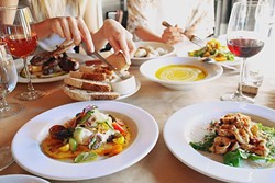 COME TOGETHER:  Kendra Aronson loves photographing big table spreads where friends are sharing good food, like this photo from a meal at Ember in Grover Beach. - IMAGE COURTESY OF KENDRA ARONSON