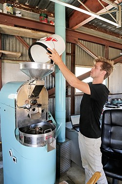 A NEW PARADIGM:  Paradigm Coffee co-founder and Roastmaster Reid Patterson roasts site-specific beans from Costa Rica with a state-of-the-art roaster he purchased from friend and fellow specialty coffee nerd Jonathan Strauf, owner of downtown coffee hub Bello Mundo. - PHOTO BY DYLAN HONNEA-BAUMANN