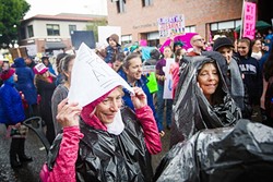 BAD WEATHER, GOOD VIBES:  Thousands of men, women, and children braved the rain to turn out at the SLO Women&rsquo;s March Jan. 21, joining an estimated 4.9 million others participating in similar marches in the U.S. and around the world. - PHOTO BY JAYSON MELLOM