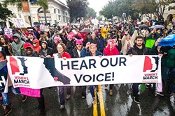 UNITY AND CHANGE:  More than 7,000 marchers flooded the streets of downtown SLO during a downpour on Jan. 21 to participate in the historic Women&rsquo;s March supporting equality and civil rights for all people, which took place in about 600 cities nationwide the day after Donald Trump&rsquo;s inauguration. - PHOTO BY JAYSON MELLOM