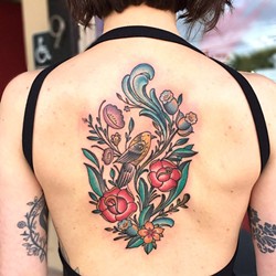 HIDDEN BEAUTY :  The upper back is also a popular spot for tattoos, like this floral design by Jake Schroeder. - PHOTO COURTESY OF JAKE SCHROEDER