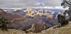 UNFATHOMABLE:  Millions of years of history are encased in the layers of exposed rock that are visible from the South Rim of the Grand Canyon. A rare break in the clouds shed light on the Colorado River, 4,000 feet below, on Dec. 24, 2016. - PHOTO BY CAMILLIA LANHAM