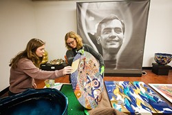 MAKING ART LOOK GOOD :  SLOMA Curator Ruta Saliklis, right, and Cal Poly student Rebecca Gates, left, prepare for an upcoming exhibit featuring the works of deceased artist Ralph Bacerra. - PHOTO BY JAYSON MELLOM