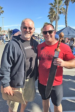 STRONG MAN:  Andrew Wickham (right) holds the California&rsquo;s Strongest Man trophy he won the last weekend in March as he stands next to World&rsquo;s Strongest Man legend Odd Haugen. - PHOTO COURTESY OF SLO STRONG