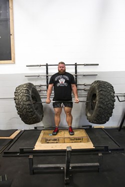 HEAVY LIFTING Scott O'Farrell of SLO Strong deadlifts a bar with a set of tires. - PHOTO BY JAYSON MELLOM