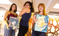 ART AND ACTIVISM Actors Jennifer McClinton, Gabrielle Duong, and Miranda Ashland hold up pieces of Ivy Bottini’s original artwork that will be featured in conjunction with the musical inclusIVity – The Ivy Bottini Story at Studios on the Park in Paso Robles. - PHOTO BY JAYSON MELLOM
