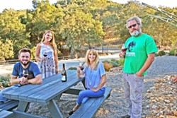 WINE RUNS IN THE FAM Lone Madrone is a family affair. From left, burgeoning winemaker Jordan Collins, Lone Madrone tasting room manager Britta Ray, General Manager Jackie Meisinger, and winemaker Neil Collins. The brother and sister duo founded the winery in 1996, and now Jordan&mdash;Neil's son&mdash;is helping out the family business. - PHOTO BY HAYLEY THOMAS CAIN