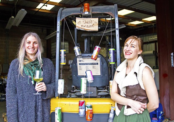 MEET THE BROADS From left, Morgan Murphy and Maggie Przybylski of Two Broads Ciderworks are making dry, crisp hard ciders in an industrial neighborhood near Broad Street in San Luis Obispo. For the co-founders, working together is a dream come true (note the "just married" sign hanging from their shared forklift, adorned with favorite cider cans). - PHOTO BY JAYSON MELLOM