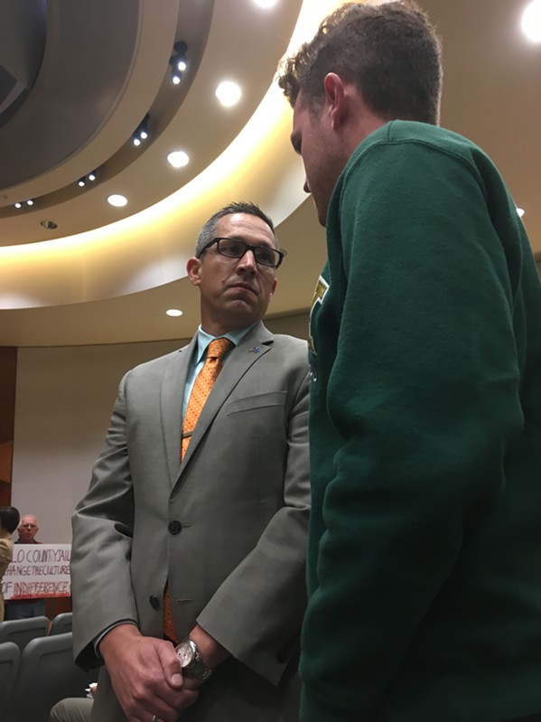 County Chief Administrative Officer Wade Horton asks protestor Matt Klepfer to move the demonstration out of the board chambers. The protestors did not, and the Board of Supervisors adjourned for the morning.