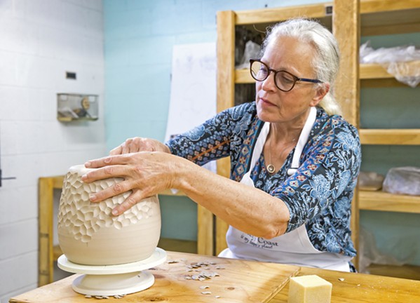 CREATE Carrie Whitaker works on shaping and molding a piece during a class or “tribe” at Pottery Coast in Grover Beach. - PHOTO BY JAYSON MELLOM