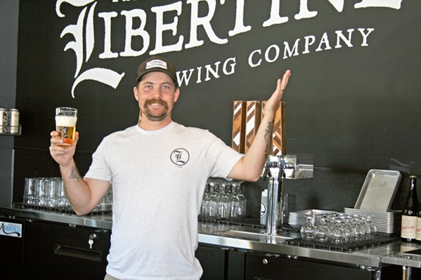 BEACH BREWER Libertine Brewing Company Founder Tyler Clark, above, can be found spinning yarns and records in between pouring beers at the new Avila Beach location, located at 90 San Miguel St. - PHOTO BY HAYLEY THOMAS CAIN