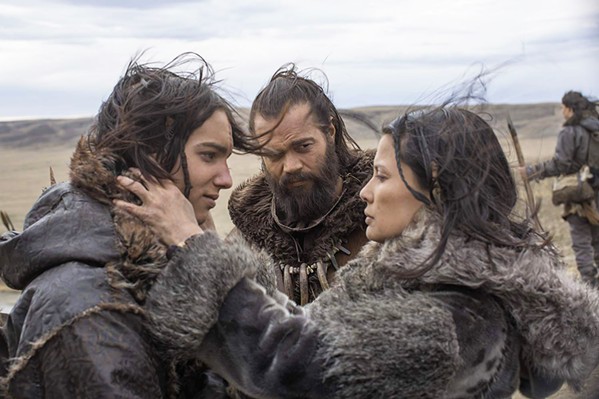 CLAN LIFE Keda (Kodi Smit-McPhee, left) is bid goodbye by his mother, Rho (Natassia Malthe, right), as he leaves on his first hunt with his father, Tau (J&oacute;hannes Haukur J&oacute;hannesson, center). - PHOTO COURTESY OF STUDIO 8