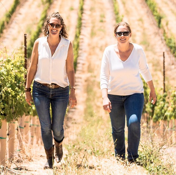 VINEYARD MEETING From left, Dream Big Darling founder and CEO Amanda Wittstrom-Higgins and a Los Angeles area wine buyer Sharon Coombs get some work done in the vines. - PHOTO COURTESY OF DREAM BIG DARLING