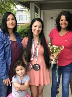 ALL ABOUT FAMILY Juarez poses for a photo with her grandmother (right), mother (left), and sister after winning top accolades at a competition in Santa Clarita last year. Juarez said she sometimes looks at a photo of her sister to inspire her before lifts. - PHOTO COURTESY OF DENISE JUAREZ