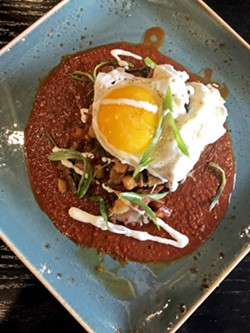 SUNNY SIDE Leroy's stuffed chile relleno is filled with tri-tip, bacon, and lingui&ccedil;a from Cattaneo Brothers, guajillo chili sauce, queso fresco, crema, and topped with a sunny-side-up egg. - PHOTO BY HAYLEY THOMAS CAIN
