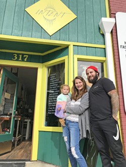 FOR A CAUSE Audra and Gabriel Glatstein (with daughter Adley Grey) recently opened Intent, a store in downtown Morro Bay that sells eclectic products that all have a charitable or sustainable bent. - PHOTO BY PETER JOHNSON