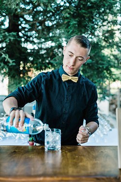 FAMILY THAT POURS One of best parts of Joslin's job is creating a bartending family that love to work with one other and interact with wedding attendees such as Luke Wills (pictured). - PHOTO COURTESY OF  LEANA MYRA PHOTOGRAPHY