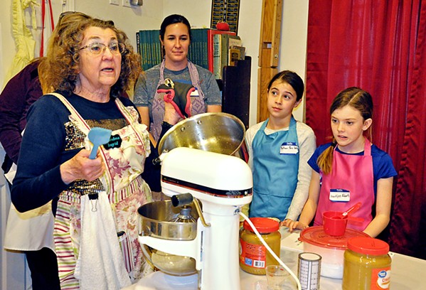 MARSHMALLOW TRICKS Holli Shelton, her daughter Mackenzi Shelton, and niece Brooklynn Roberts watch as Grandma Ingrid Hilton pours a heated sugar mixture into a waiting bowl that contains gelatin, water, and vanilla. She talks to the class as she works: After approximately seven minutes of mixing, it will have the right gloss and texture. - PHOTOS BY CAMILLIA LANHAM