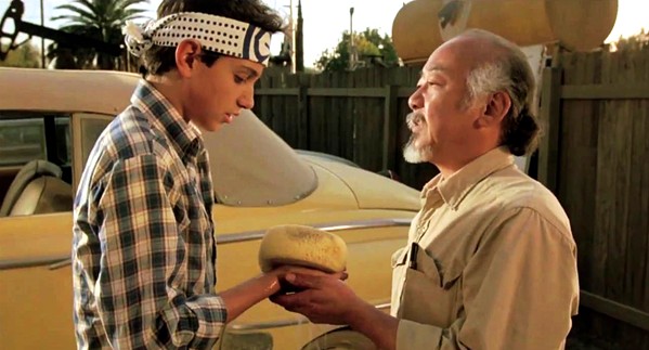 WAX ON, WAX OFF A martial arts master (Pat Morita) agrees to train his 15-year-old neighbor (Ralph Macchio), in The Karate Kid, which screens in celebration of its 35th anniversary at Downtown Centre on March 31 and April 2. - PHOTO COURTESY OF COLUMBIA PICTURES