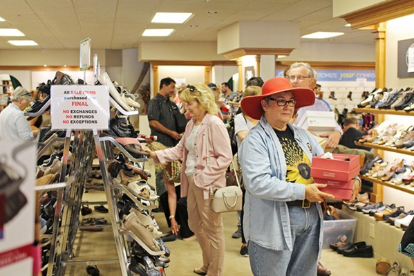 A PIVOTAL STORE LOST Customers take advantage of huge closing sales at Charles Shoes on Aug. 15. The store closed this summer after more than 50 years in business. - PHOTO BY KASEY BUBNASH