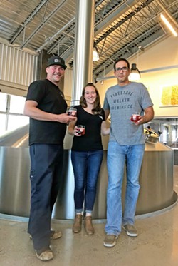 ROOTED IN WINE It makes sense that Firestone Walker Brewery got back to its roots in wine. Their very first beers were fermented in wine barrels. Pictured (from left to right) are Head Brewer Dustin Kral, Quality Control Manager Amy Crook, and Production Director Ali Razi. - PHOTO BY BETH GIUFFRE