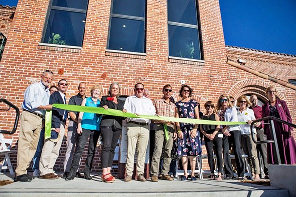 RIBBON CUTTING Local elected officials and nonprofit leaders attend the grand opening of the Bishop Street Studios on Nov. 16. The apartment complex will permanently house locals who are low income and living with mental illness. - PHOTO COURTESY OF THE CITY OF SAN LUIS OBISPO