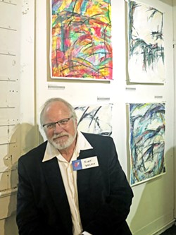 FEATURED Kurt Waldo, a featured artist in Cambria Gallery of Art's Winter Show, sits in front of a few of his pieces he calls "abstract expressionism." - PHOTO BY MALEA MARTIN