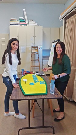 GETTING CREATIVE Student Nathaly, 14, works with Paso Robles Youth Art Foundation Executive Director Mindy Dierks on a surfboard-shaped sign for The Ravine Water Park in Paso Robles. - PHOTO BY REBECCA HOWES