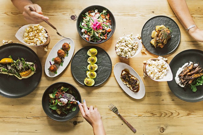 FAMILY STYLE With a focus on shareable plates, The Alchemists' Garden menu includes tapas-style items such as turmuric deviled eggs, head-on prawns, croquettes, and glazed baby carrots, as well as plates like the Moroccan spiced lamb and coffee-rubbed skirt steak.