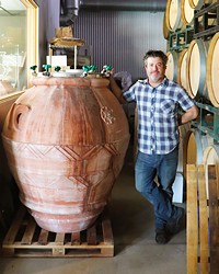 ANCIENT METHODS Christopher Ferrara, proprietor and winemaker with Clesi Wines, poses next to an amphora almost as tall as him. Clesi Wines is one of more than a dozen local wineries that are reviving the ancient amphora winemaking method.