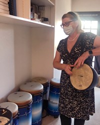 COMMUNITY LEADER Sonya Jackson facilitates drum circles at Hospice SLO with blue Remo hand drums of mixed sizes.