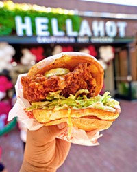 CROWING FOR MORE HellaHot's hot chicken sandwich comes with a breaded chicken breast lacquered with spicy oil and topped with pickles, cooling coleslaw, and lashings of their special sauce.