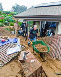 HELPING HANDS Volunteers help clear mud from Phyllis Schoonbeck's house in Los Osos after a mudslide on the evening of Jan. 9 brought devastation to her home and several others on Vista Court in Los Osos.