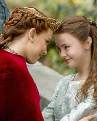 SISTERLY LOVE Elodie (Millie Bobby Brown, left) and her sister, Floria (Brooke Carter), share a moment on Elodie's wedding day, both unaware that Elodie must soon battle a dragon, in Damsel, streaming on Netflix.