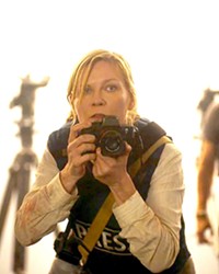 WAR-CORE DESPONDENT Kirsten Dunst stars as Lee Smith, a hardened journalist covering a new American civil war, who's racing to Washington, D.C., as the seceding states' militias invade, in Civil War, screening in local theaters.