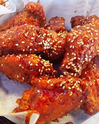 CRUNCHY PERFECTION Served with a pair of plastic gloves, Hana Korean BBQ prepares eight large pieces of crispy fried chicken in a traditional sweet and spicy yangnyum sauce.