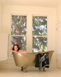 A CLEANSING EXPERIENCE Sanitarium staff member Heidi Harmon floats in a Moroccan bathtub that comes standard in every room.