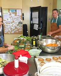 HEALING THROUGH THE KITCHEN Volunteers work daily at The Wellness Kitchen and Resource Center to learn about and prepare healthy foods.