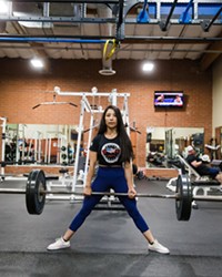 RAISING THE BAR Inside FitnessWorks of Morro Bay, Denise Juarez attempts a deadlift, one of the three lifts in powerlifting.