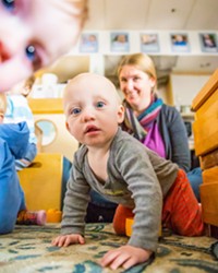 CARE WANTED Nova, who attends the Cal Poly ASI Children's Center, appears intrigued by New Times photographer Jaysom Mellom. Infant care is an often unmet and rapidly growing need in SLO County.