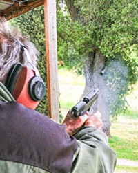 SEMI AUTO ACTION A spent cartridge jumps from musician and Vietnam vet Don Lampson's .45 as he target shoots at his Santa Margarita ranch.