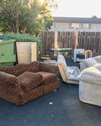 IS THIS THE DUMP? Couches, chairs, tables, and a mini-fridge sit outside an apartment complex near Cal Poly just before San Luis Garbage's fall Cleanup Week.