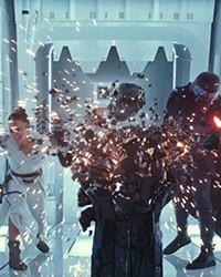 BATTLING THE DARK SIDE As the Resistance weakens, Rey (Daisy Ridley) battles the forces behind the Sith, including the troubled Kylo Ren (Adam Driver).