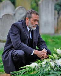 MOURNING FATHER NYC police detective Jacob Kanon (Jeffrey Dean Morgan) tracks a pair of serial killers butchering young married couples throughout Europe, in The Postcard Killings, a murder mystery screening on Hulu.