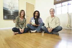 PHOTO BY STEVE E. MILLER - TWISTS AND TURNS :  Ahmed Fahmy, who&rsquo;s flanked by Karen and Bryan Duggan, teaches children yoga techniques and environmental care on an award-winning, locally produced DVD.